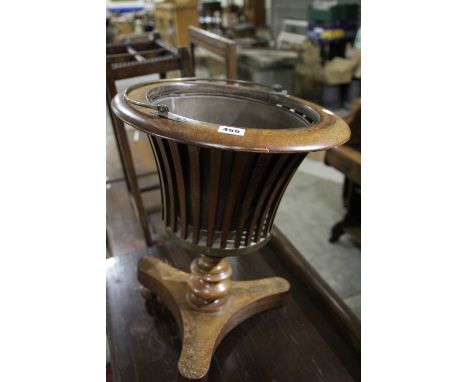 A Mahogany Wine Cooler On A Tripod Base