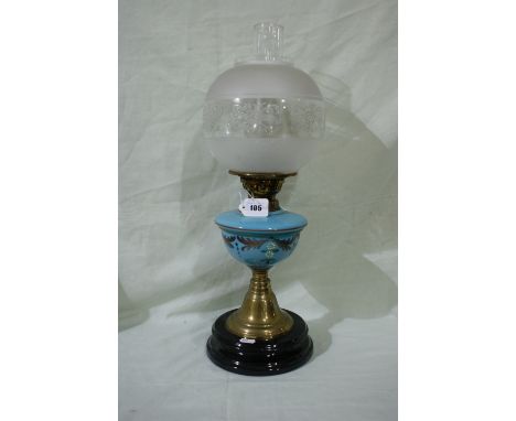 A Circular Based Brass Column Oil Lamp With Blue Milk Glass Reservoir And Etched Shade