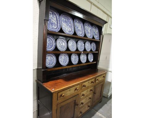 A 19th Century Oak And Mahogany Anglesey Dresser Having A Three Shelf Rack, The Base With Two Side Cupboards Each With Drawer