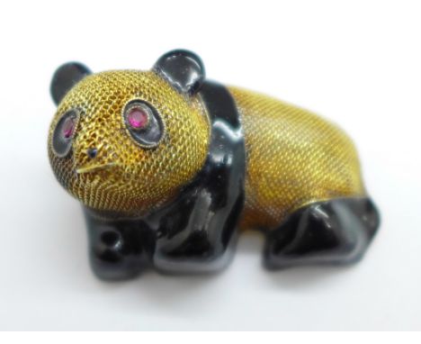A silver gilt and enamel panda brooch 