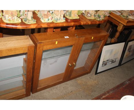 An oak glazed cabinet with one glass shelf 