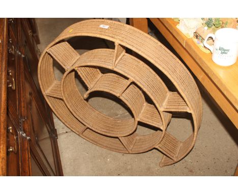 A split cane hanging wall shelf of spiral form
