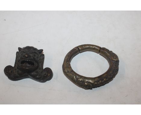 A bronze bangle and a bronze mask