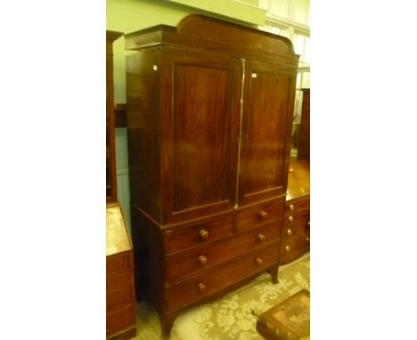 A 19TH CENTURY MAHOGANY LINEN PRESS, having raised moulded crest over two door top, on base fitted two short and two long dra