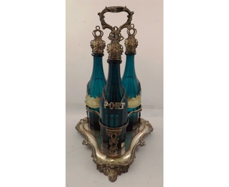 VICTORIAN SHEFFIELD PLATE WINE BOTTLE CARRIER, raised on fruiting vine feet with central carrying handle, fitted three facet 