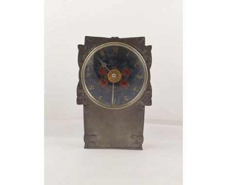 ARCHIBALD KNOX A LIBERTY TUDRIC PEWTER MANTEL CLOCK having Art Nouveau foliate case and enamel dial, decorated with berries, 