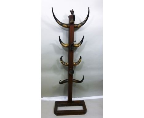 A VICTORIAN MAHOGANY HAT AND COAT STAND, the veneered post with turned urn finial, fitted eleven polished cow horns with meta