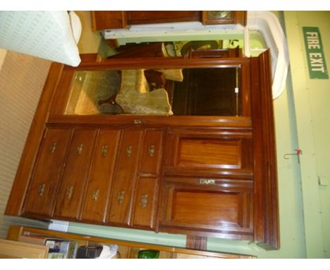 A "MAPLE &amp; CO." MAHOGANY COMPACTUM WARDROBE, having moulded crest and frieze over a hanging section, with mirrored door t