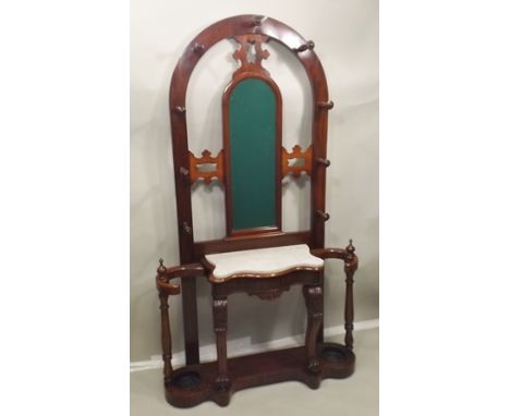 A VICTORIAN DESIGN MAHOGANY HALL STAND having arched back with turned coat hooks, about a mirror over a serpentine marble pla