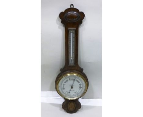 A "LANCASTER & THORPE LTD" OAK FRAMED WALL BAROMETER with thermometer, having silvered calibrated dials, main dial 19cm diame