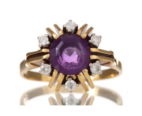 PURPLE PASTE AND DIAMOND CLUSTER RING LATE 20TH CENTURY  the round purple gem surrounded by small diamonds, marked 750, size 