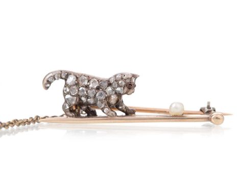 DIAMOND CAT BROOCH set with rose cut diamonds and ruby eyes, depicted playing with a pearl, 35mm long, unmarked, likely silve