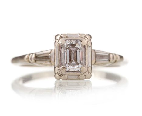 DIAMOND SOLITAIRE RING set with central emerald cut diamond of approximately 0.40 carats, on diamond shoulders, marked 14K, s