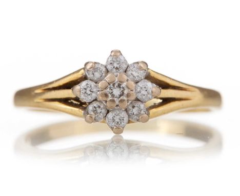 DIAMOND FLOWER CLUSTER RING set with round brilliant cut diamonds totalling approximately 0.15 carats, in eighteen carat gold