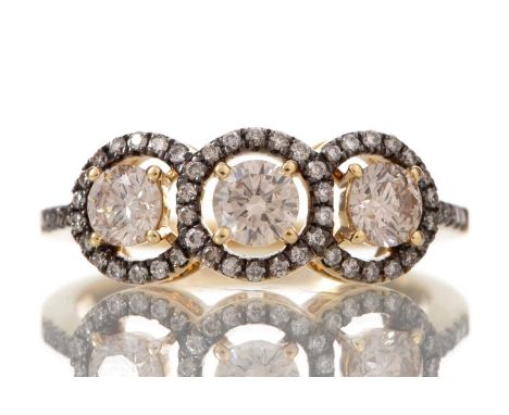 COGNAC DIAMOND THREE STONE HALO RING set with round brilliant cut diamonds totalling approximately 0.80 carats, in eighteen c