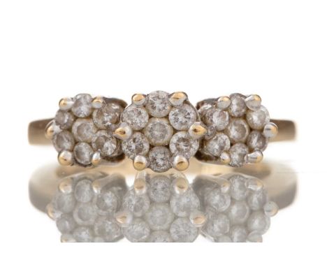 DIAMOND TRIPLE DAISY CLUSTER RING set with round brilliant cut diamonds, in eighteen carat gold, size N 1/2, 6.1g