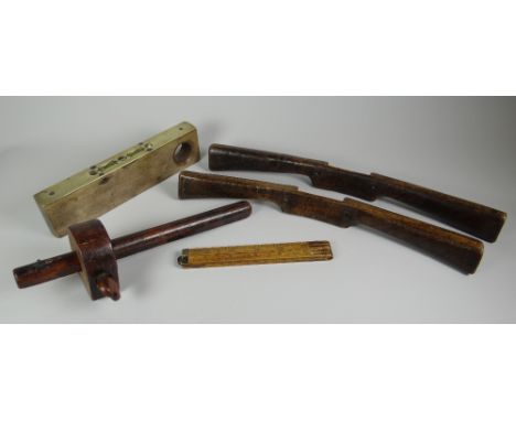 A PARCEL OF TREEN TOOLS comprising pair of spoke-shaves, beech-wood and brass spirit level, folding measure and treen gauge