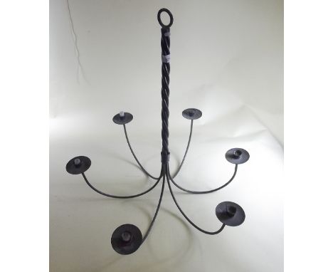 A large metal six branch candle holder light fitting