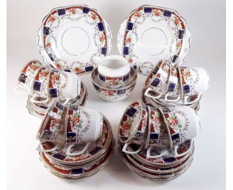 An Edwardian tea service comprising: eleven cups, twelve saucers, milk jug and sugar, twelve tea plates and two cake plates