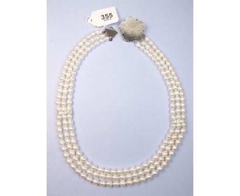 A freshwater pearl three strand necklace with flower clasp