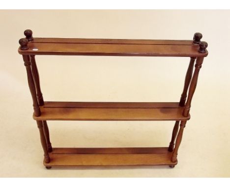 A mahogany finish ornament shelf