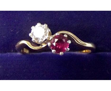 A 9ct gold ruby and diamond crossover ring, size N