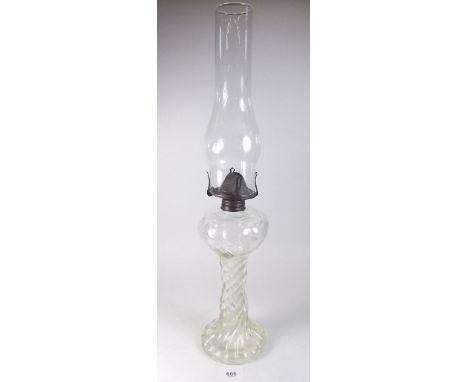 A glass oil lamp with twisted stem