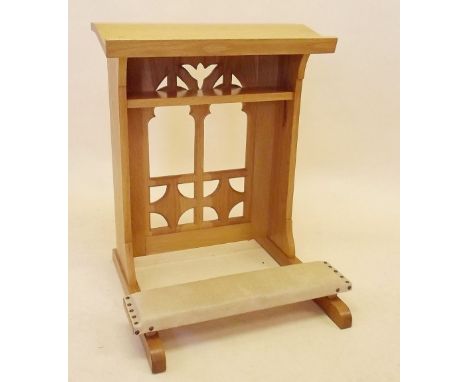 A light oak ecclesiastical priests prayer stand with book rest and shelf over gothic carved screen and fold out kneeler