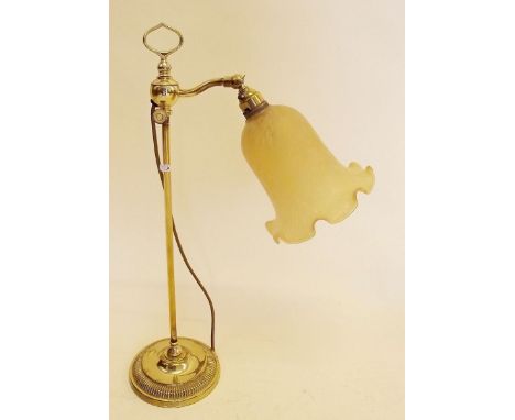 A mid 20th century brass students lamp with amber frilled glass shade