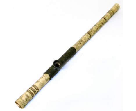 A Chinese carved bone opium pipe. Showing figures in a landscape surrounded by cherry blossoms. 50 cm length.