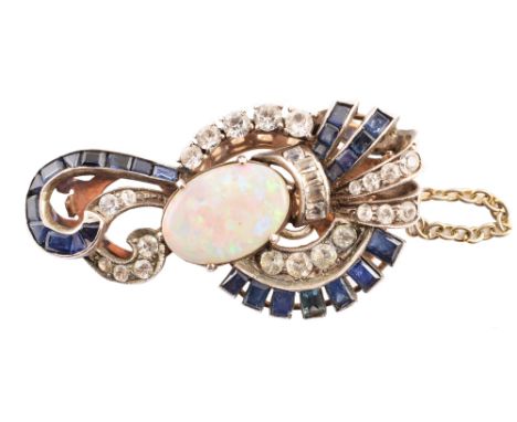 Art Deco opal, white and blue sapphire set clip , scrollwork open design comprising central oval cabochon cut opal measuring 