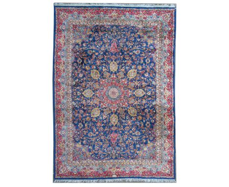 Late 20th century Kerman design carpet, indigo blue field with central medallion surround by floral tendril and rosette desig