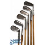 6x Maxwell golf irons incl a medium iron, a jigger, a 'Baxspin' mashie with diamond pattern and