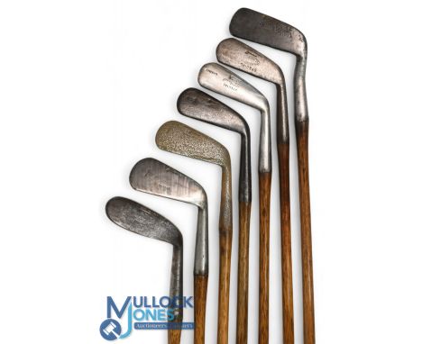 7x Assorted Tom Stewart irons features an R Walker mashie niblick, 2x mashies, a no 3 iron, a mid iron stamped Anderson and B