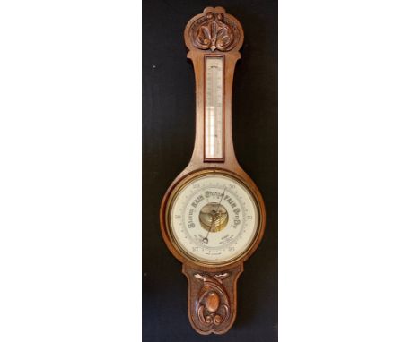 A 20th century oak banjo-shaped barometer, carved in a arts and crafts manner, 81cm high 