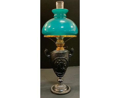 A 19th century cast iron oil lamp, painted black, 28cm high 