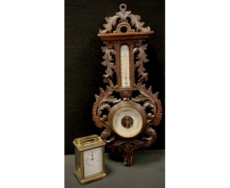 A carved oak Barometer, 49cm long; Brass carriage clock (2) 