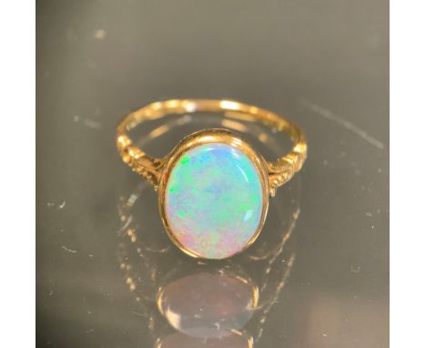 An opal cabochon doublet ring, measuring approx 10.80mm x 8.89mm x 2.94mm, with vibrant green blue and violet colour play, op