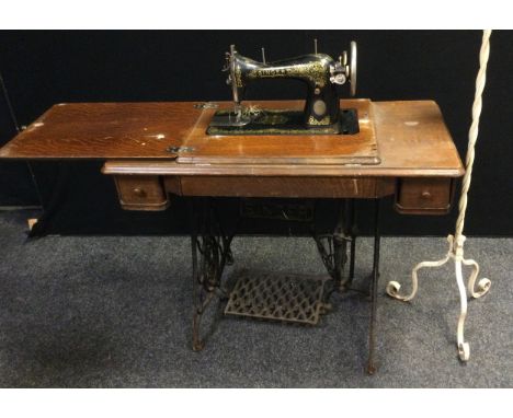 A Singer Treadle sewing machine, C1394618, cast iron base;  a wrought iron standard lamp (2) 
