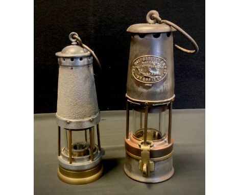 A Wolf Patterson Miner’s Safety Lamp No. 7R, 29cm high;  another, Deco Ltd., safety lamp, (2). 
