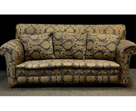 An late Victorian/early 20th century three seater drop end sofa, upholstered in deep blue and gold floral fabric, 84cm high, 