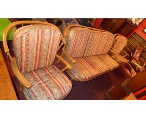 SOLD IN TIMED AUCTION An Ercol style three piece suite comprising settee and two armchairs with upholstered cushions