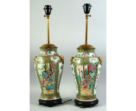 A PAIR OF CHINESE CANTON FAMILLE ROSE PORCELAIN LAMP VASES, painted with panels of figures as well as birds, butterflies and 