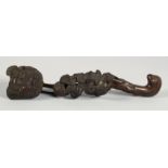 A CHINESE CARVED WOOD RUYI SCEPTRE, of naturalistic form and further carved with bats, 34cm long.