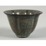 A CHINESE GE WARE PETAL FORM CUP, 8.5cm diameter.