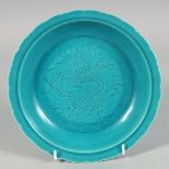 A CHINESE TURQUOISE GLAZE PETAL FORM DISH, the centre decorated with incised dragon and stylised