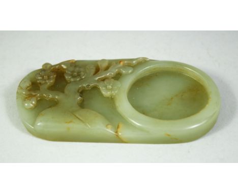 A CHINESE CARVED JADE INK STONE, 11cm x 6cm.