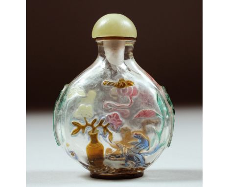 A SUPERB CHINESE ROCK CRYSTAL SNUFF BOTTLE AND JADE STOPPER, with carved and stained decoration depicting flora and fauna, wi
