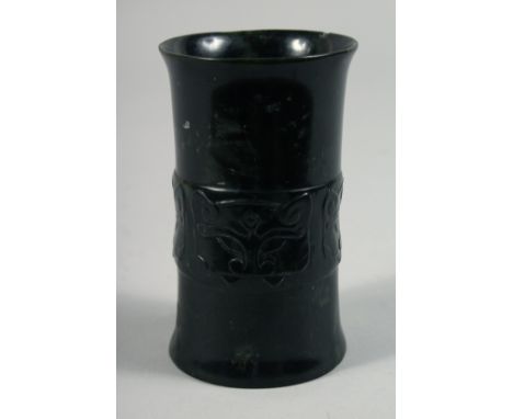 A CHINESE JADE HOLLOW CYLINDER, with a band of carved decoration, 11.5cm.