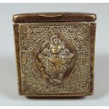 A TIBETAN BRASS TRAVELLING SCROLL BOX, with hinged lid and repousse decoration, 8cm x 8cm.